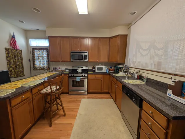 a view of a kitchen with stove and cabinets