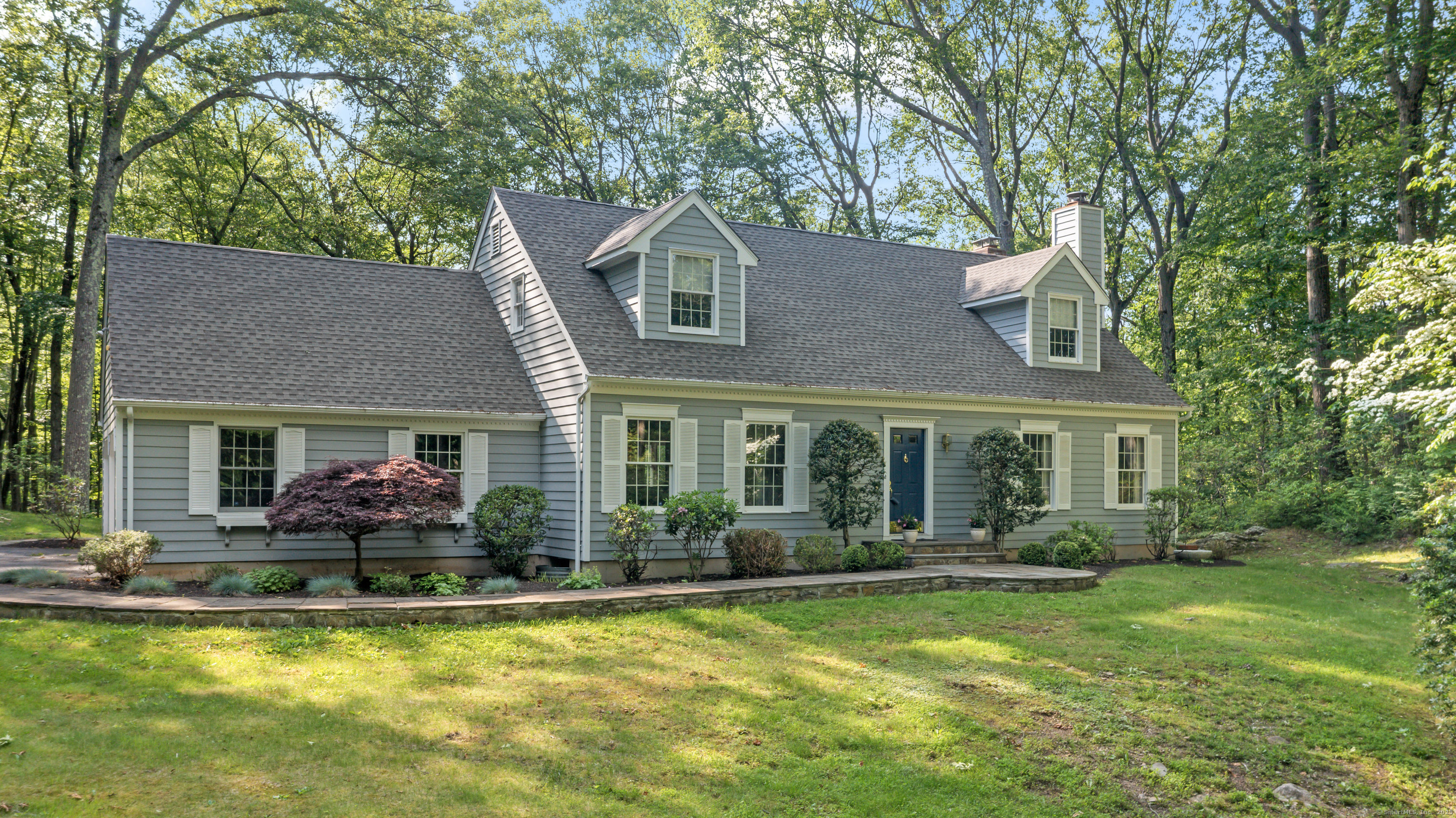 a front view of house with yard and outdoor seating