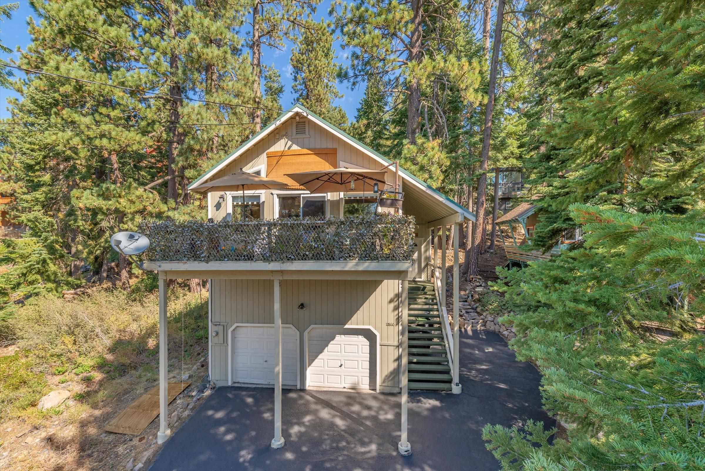 12860 Dulzura Street Truckee, CA 96161 - Photo 1 of 21 a front view of a house with a yard and garage