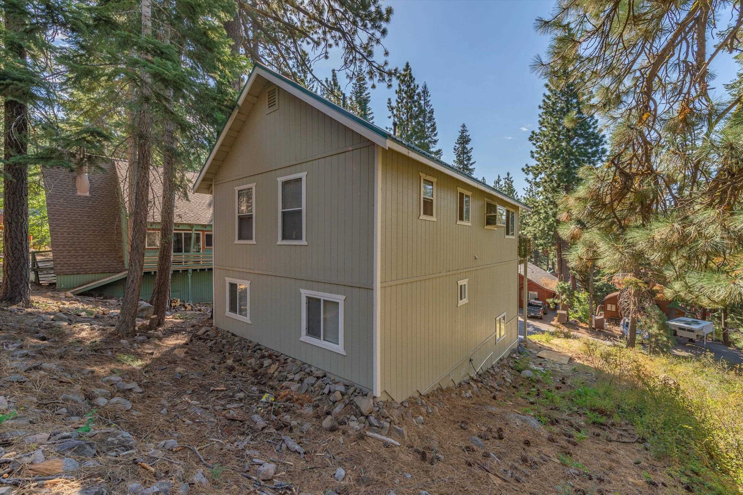 12860 Dulzura Street Truckee, CA 96161 - Photo 17 of 21 a view of a house with a yard and large tree
