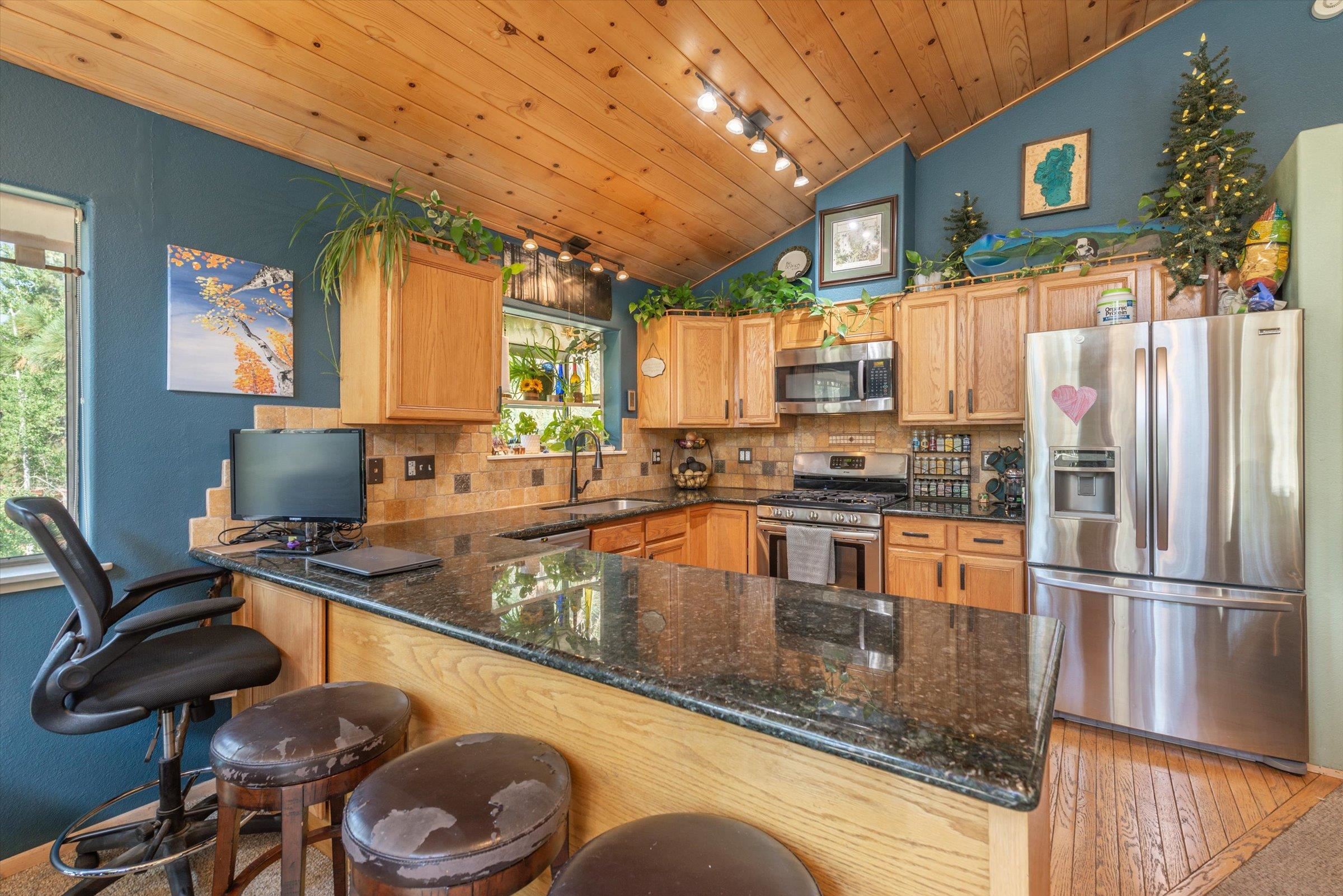 12860 Dulzura Street Truckee, CA 96161 - Photo 19 of 21 a kitchen with stainless steel appliances granite countertop a sink a stove and a refrigerator
