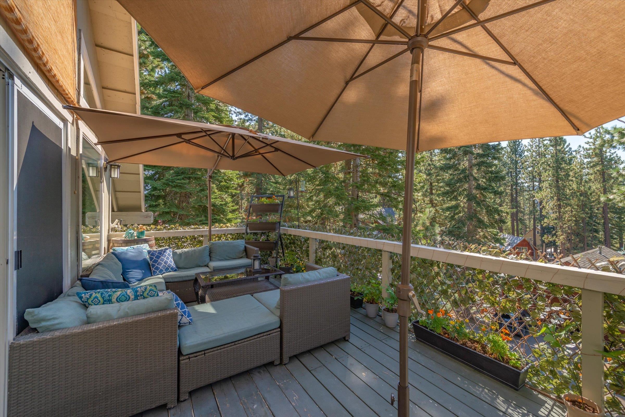 12860 Dulzura Street Truckee, CA 96161 - Photo 20 of 21 a view of a roof deck with couches under an umbrella