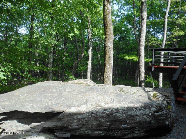 105 Ridge Road Hawley, PA 18428 - Photo 8 of 41 a backyard of a house with large trees and outdoor seating