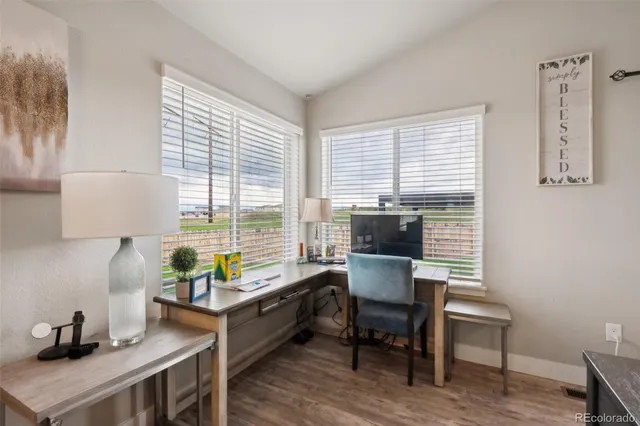a view of a workspace with furniture and a window