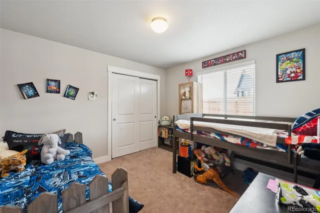 a bedroom with furniture and a baby crib