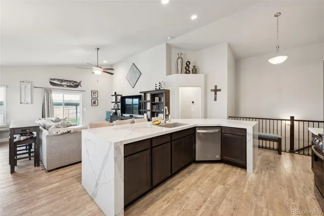 a kitchen with stainless steel appliances granite countertop a sink and stove