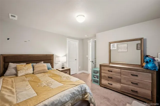 a bedroom with a bed and a dresser