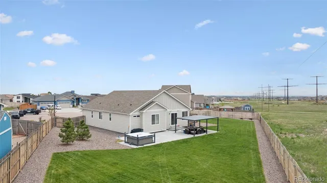an aerial view of a house with a garden and deck