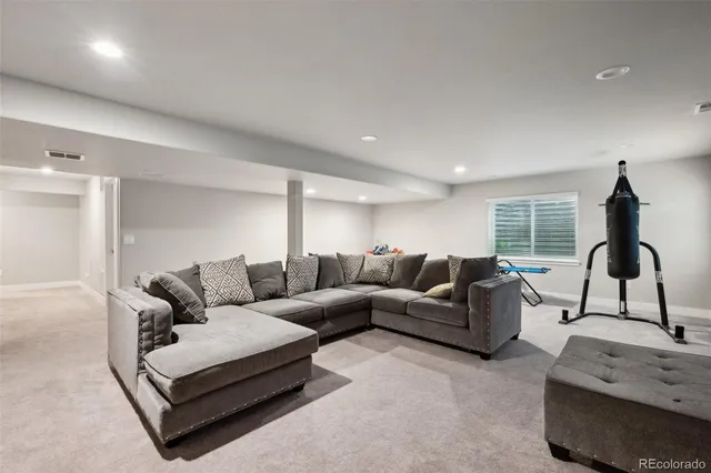 a living room with furniture a window and a lamp