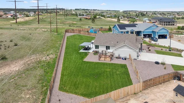 a aerial view of a house with a yard
