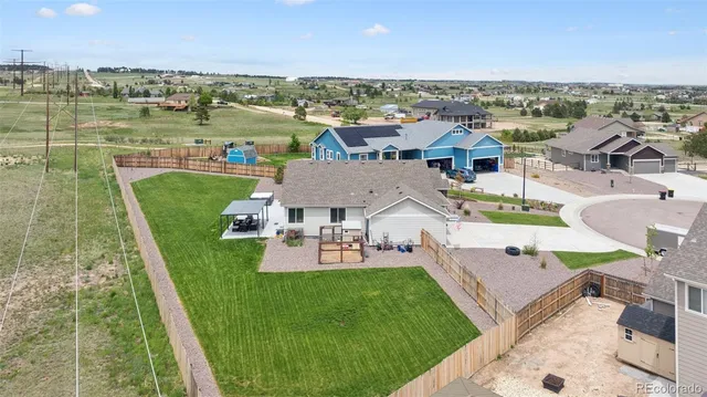 an aerial view of a house with a big yard