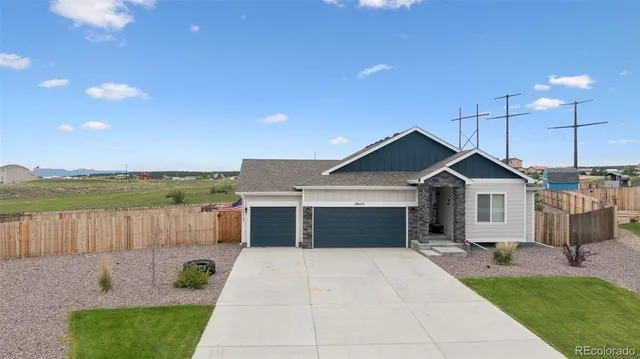 a front view of a house with a yard and a garage