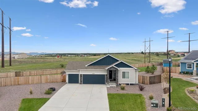 a view of a house with a yard and sitting area