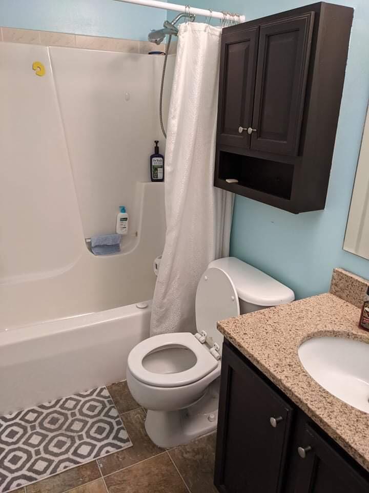 369 South Boo Road, Unit B Burns Harbor, IN 46304 - Photo 19 of 23 a white toilet sitting next to a bath tub