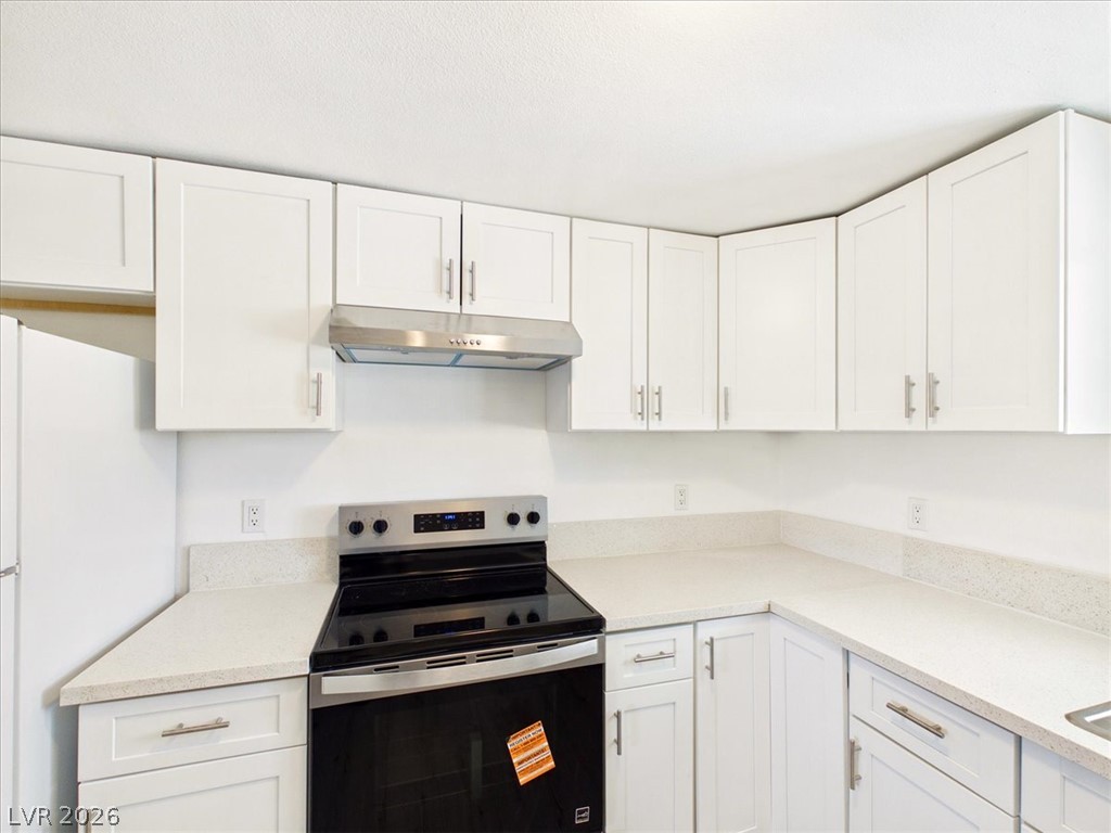 4081 Retread Road Pahrump, NV 89048 - Photo 20 of 98 A well-appointed kitchen features ample white cabinetry and pristine countertops, perfect for culinary endeavors.