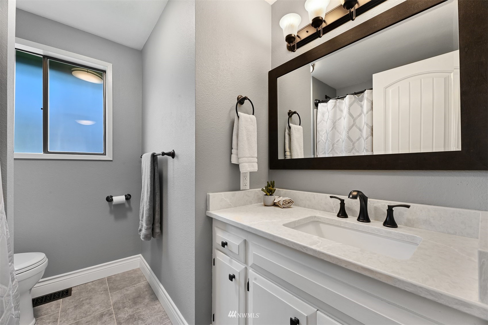 232 Bayside Road Bellingham, WA 98225 - Photo 34 of 40 a bathroom with a sink a toilet and mirror