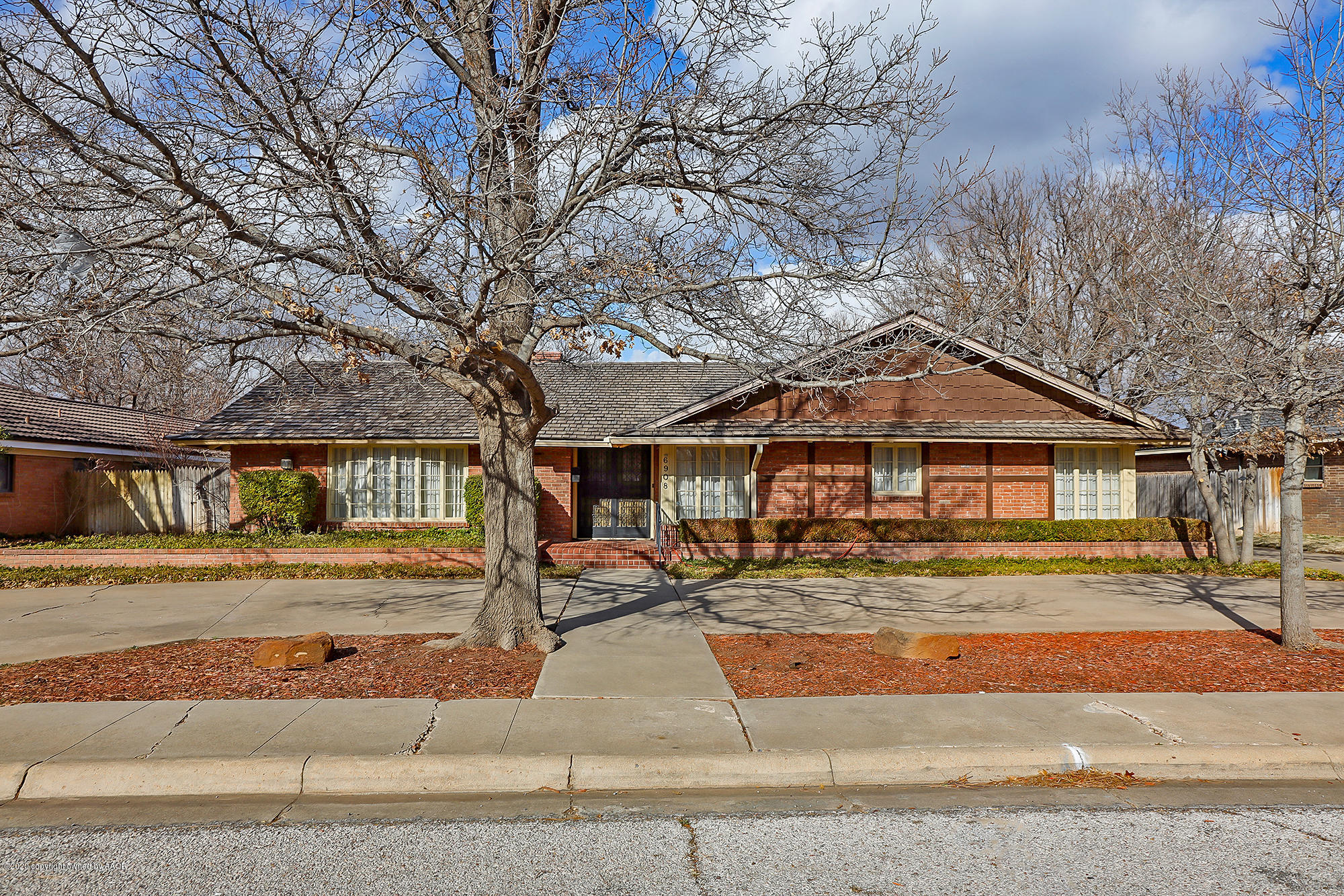 6908 Calumet Road Amarillo, TX 79106 - Photo 1 of 40 a front view of a house with a yard
