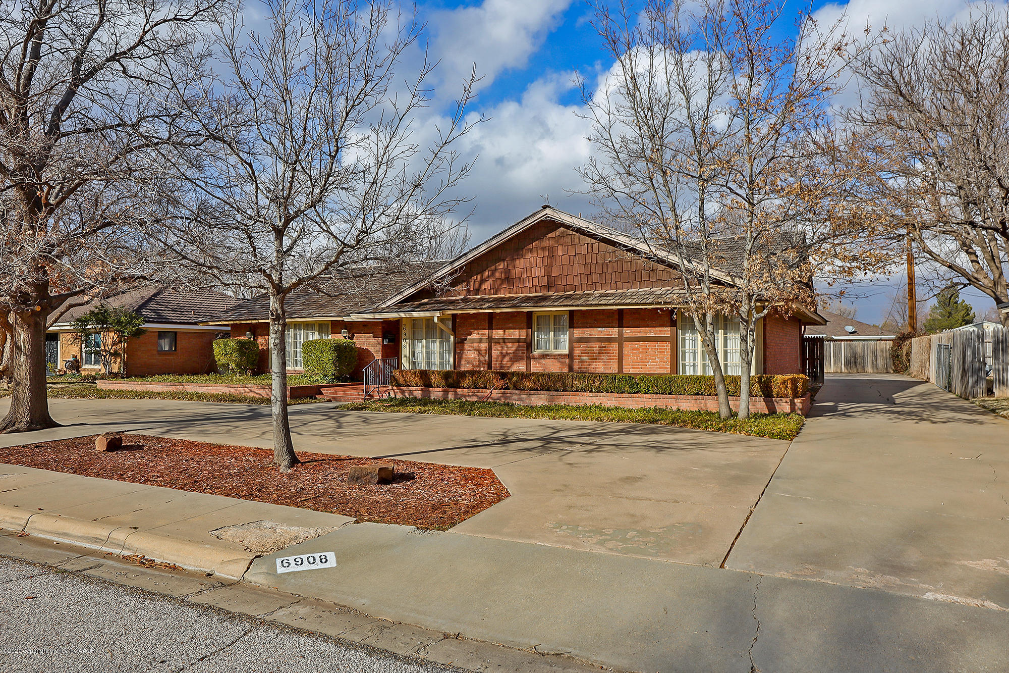 6908 Calumet Road Amarillo, TX 79106 - Photo 2 of 40 a front view of a house with a yard and garage