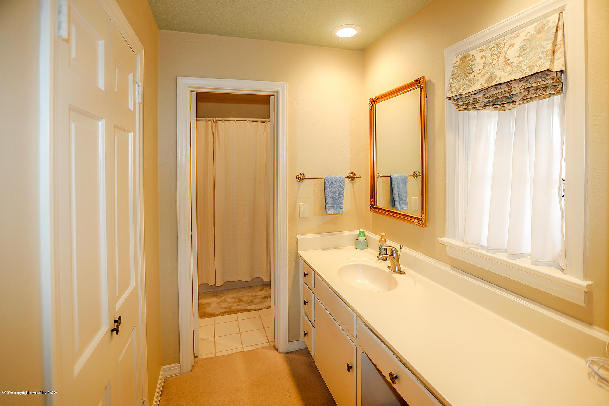 6908 Calumet Road Amarillo, TX 79106 - Photo 18 of 40 a bathroom with a granite countertop sink and a mirror