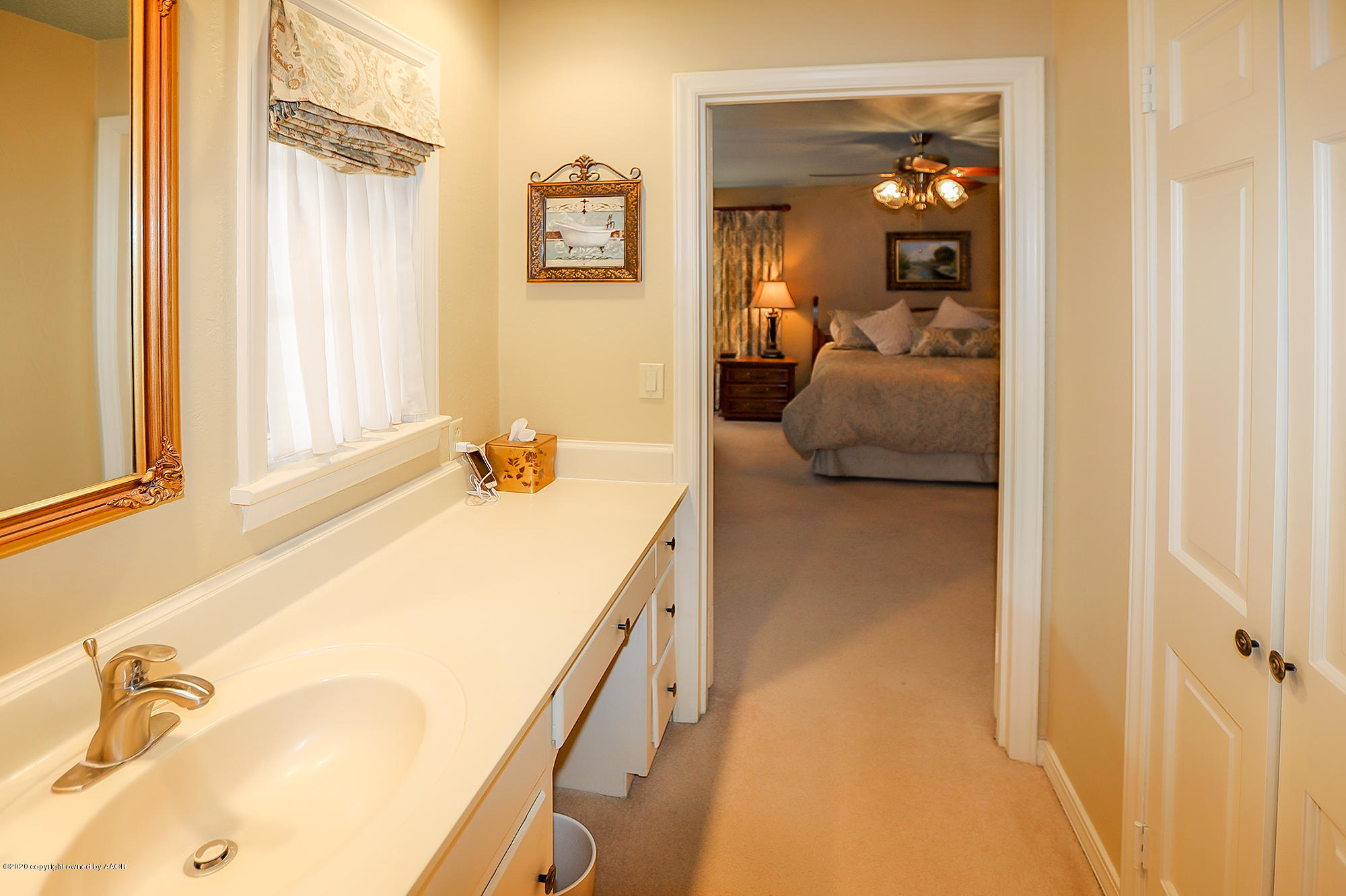 6908 Calumet Road Amarillo, TX 79106 - Photo 19 of 40 a en suite bathroom with a granite countertop sink and a mirror