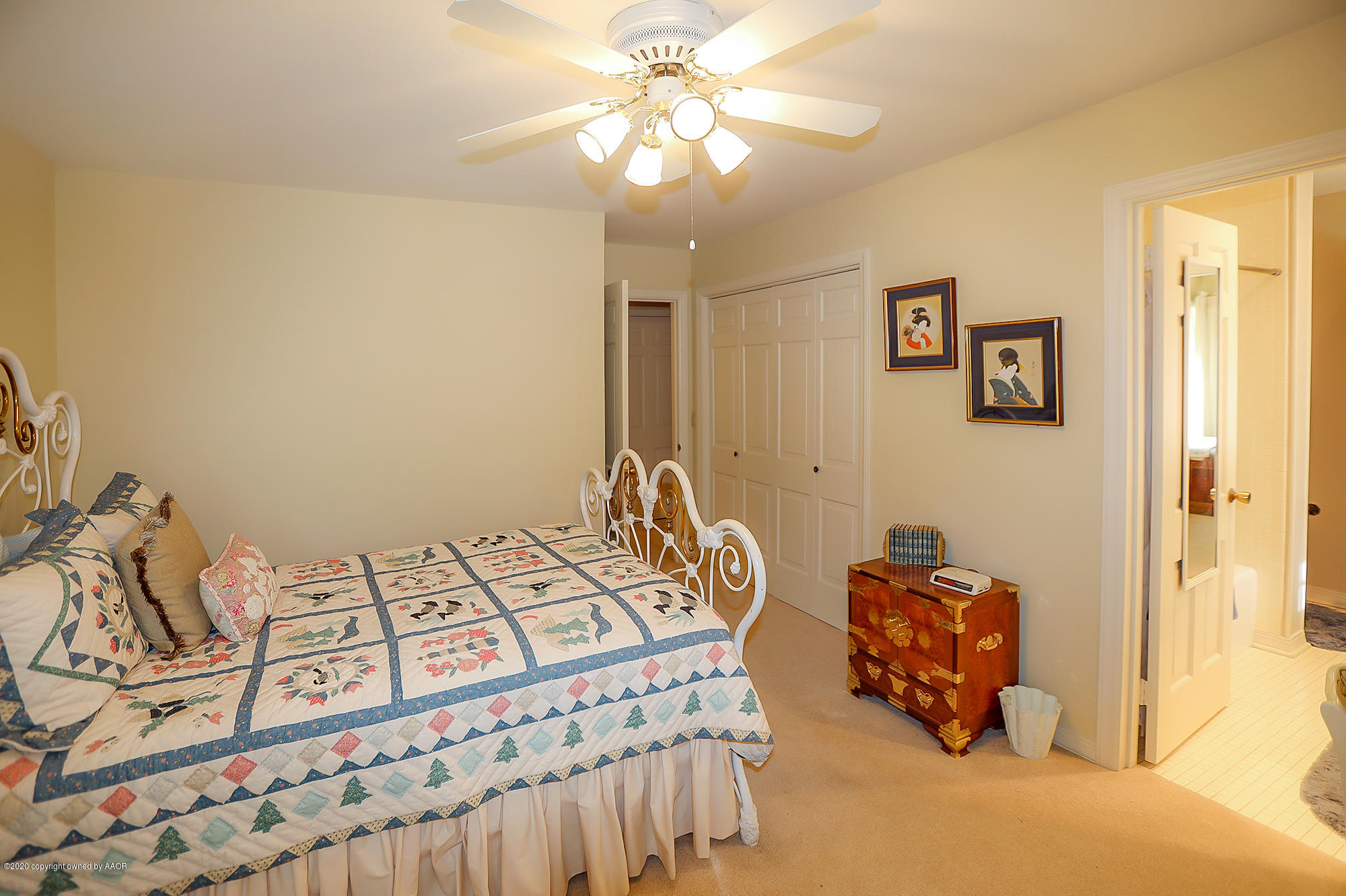 6908 Calumet Road Amarillo, TX 79106 - Photo 23 of 40 a bedroom with a bed and a chandelier