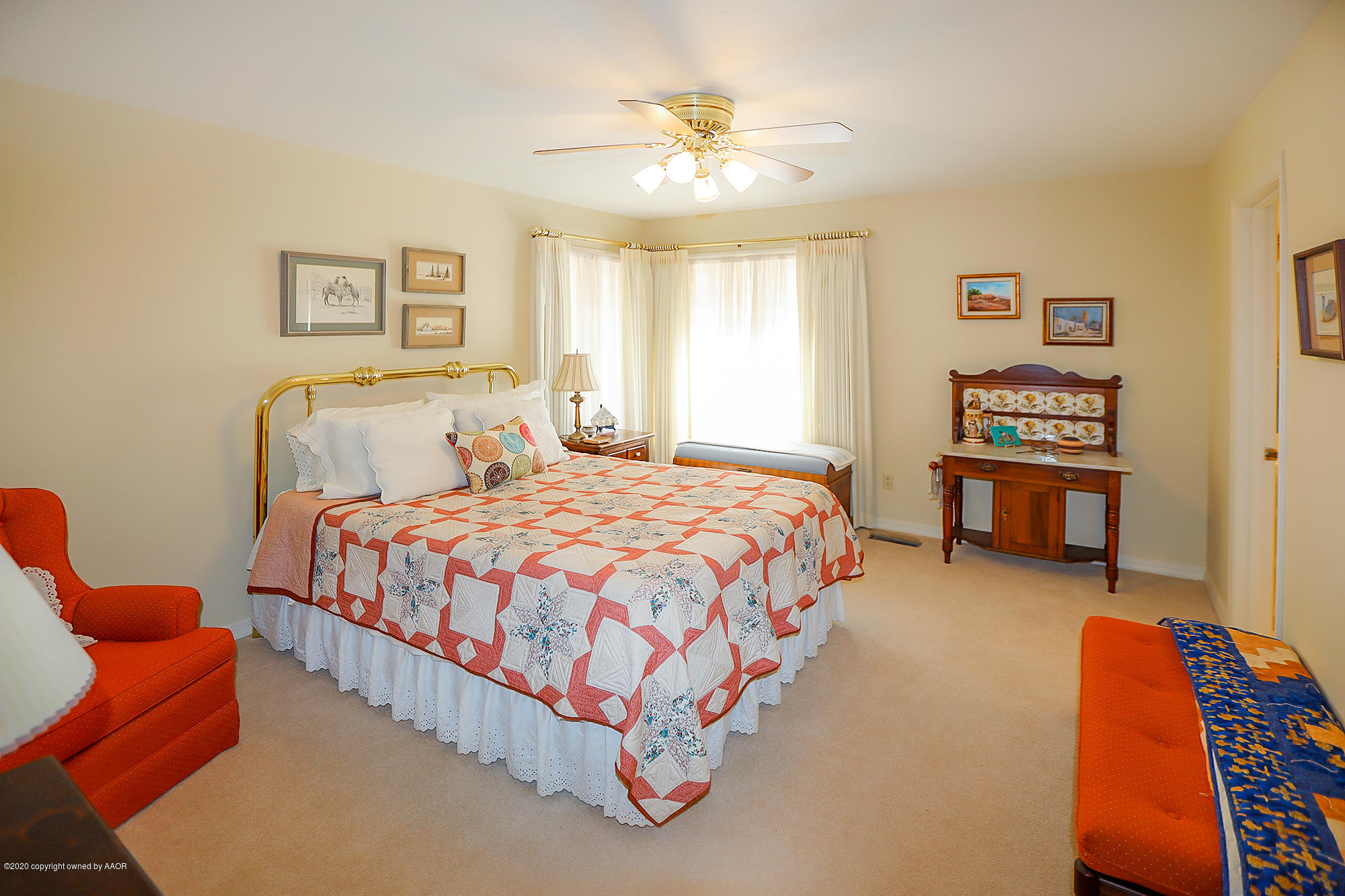 6908 Calumet Road Amarillo, TX 79106 - Photo 24 of 40 a spacious bedroom with a bed and a chandelier