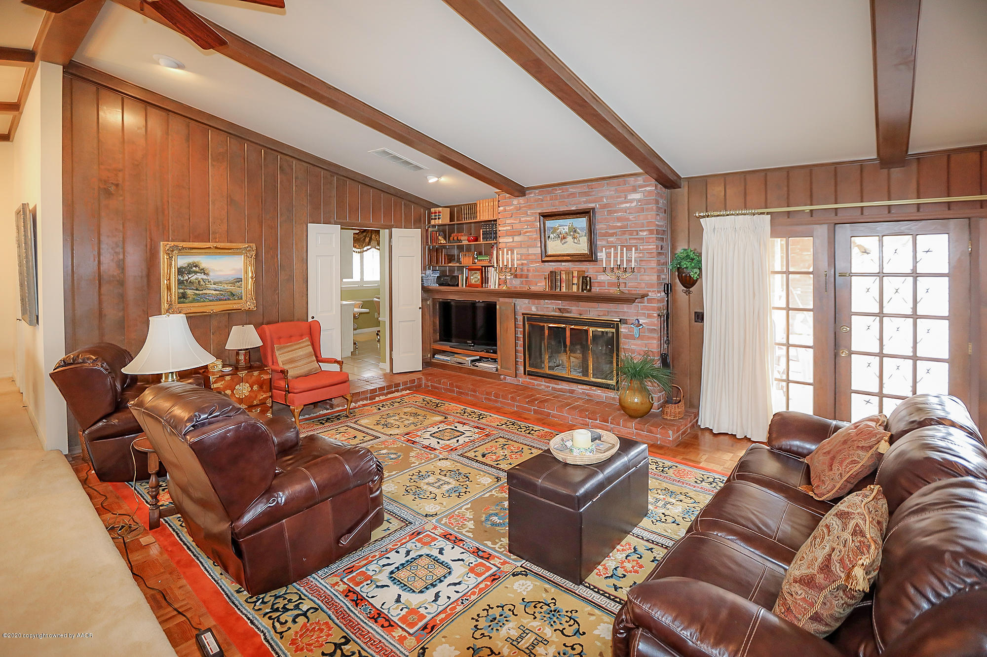 6908 Calumet Road Amarillo, TX 79106 - Photo 6 of 40 a living room with furniture windows and a fireplace
