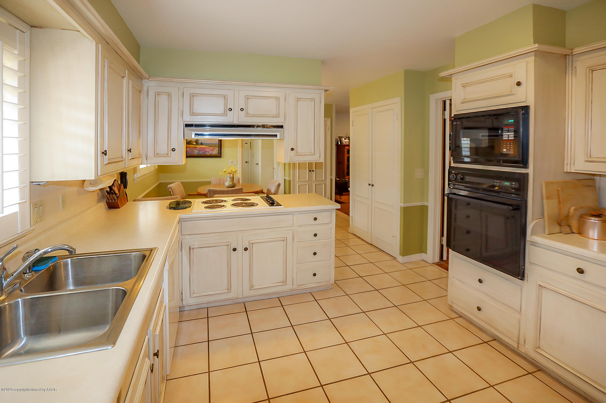 6908 Calumet Road Amarillo, TX 79106 - Photo 8 of 40 a kitchen with a stove sink and cabinets