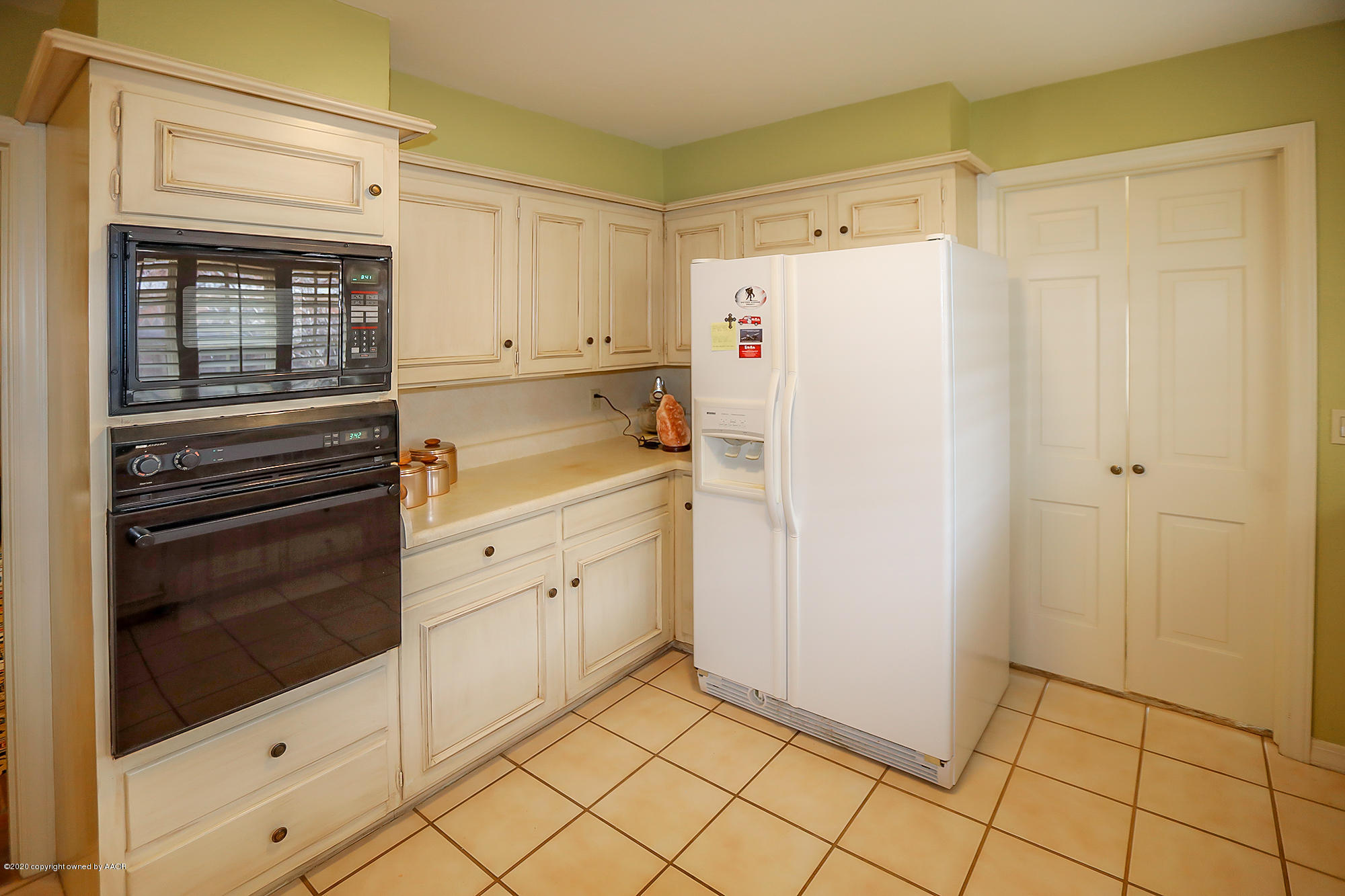 6908 Calumet Road Amarillo, TX 79106 - Photo 9 of 40 a white refrigerator freezer sitting inside of a kitchen