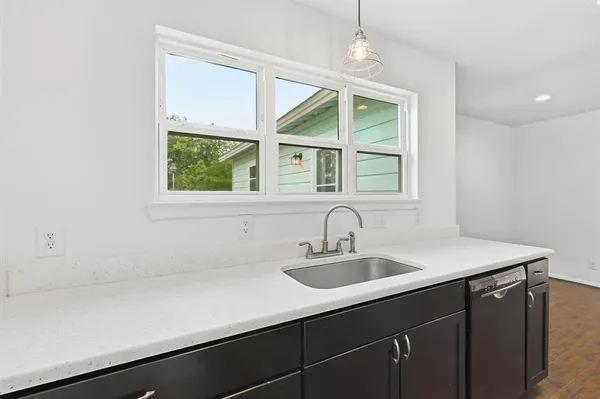 a kitchen with a sink and a window