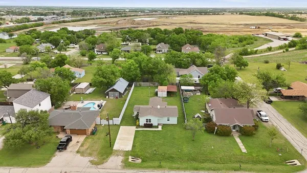 an aerial view of a house with a garden and lake view