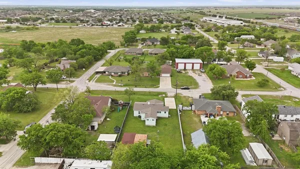 an aerial view of residential houses with outdoor space and river