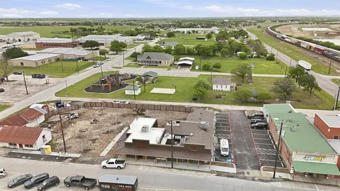 an aerial view of residential houses with outdoor space