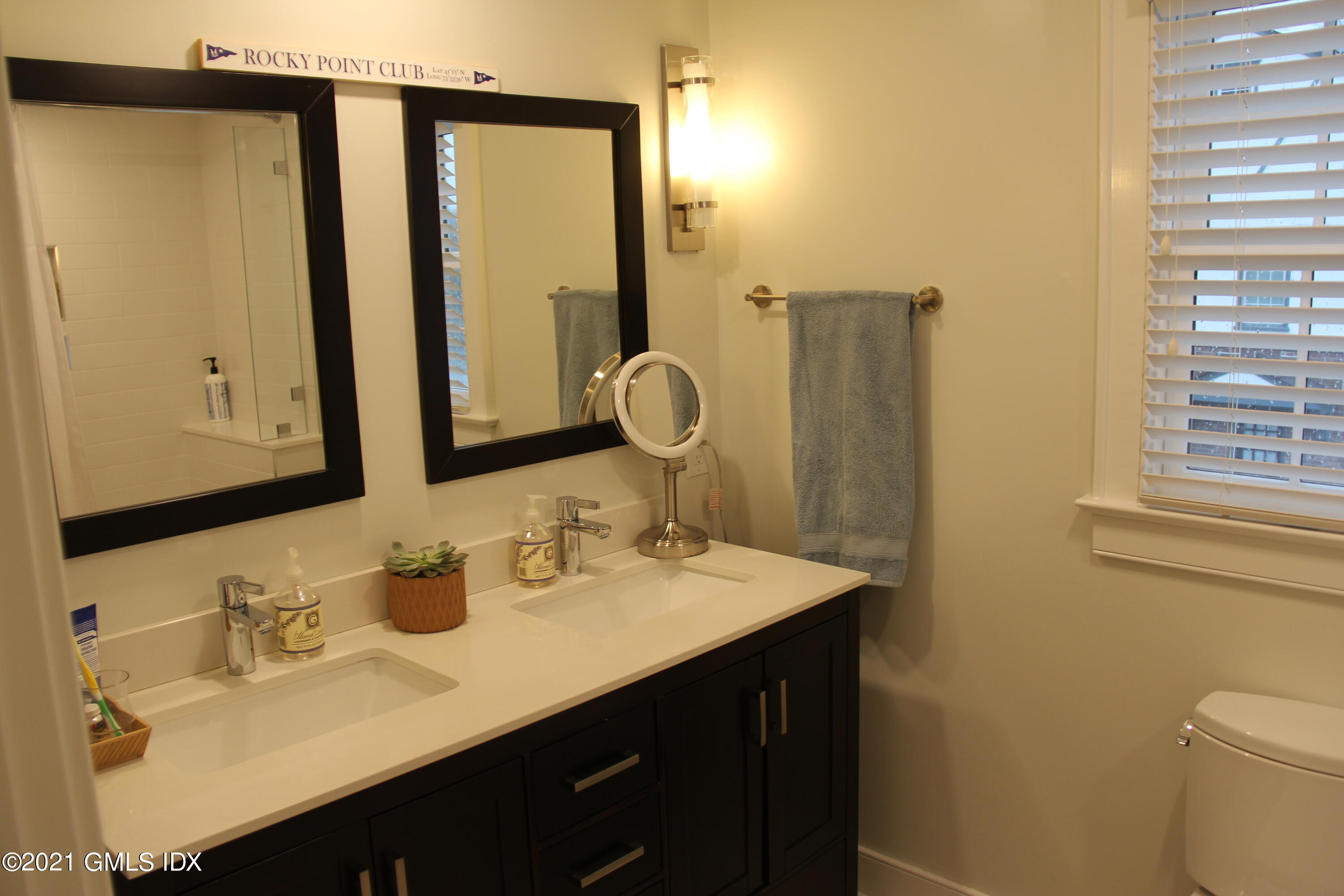 40 Strickland Road Cos Cob, CT 06807 - Photo 12 of 22 a bathroom with a sink and a mirror