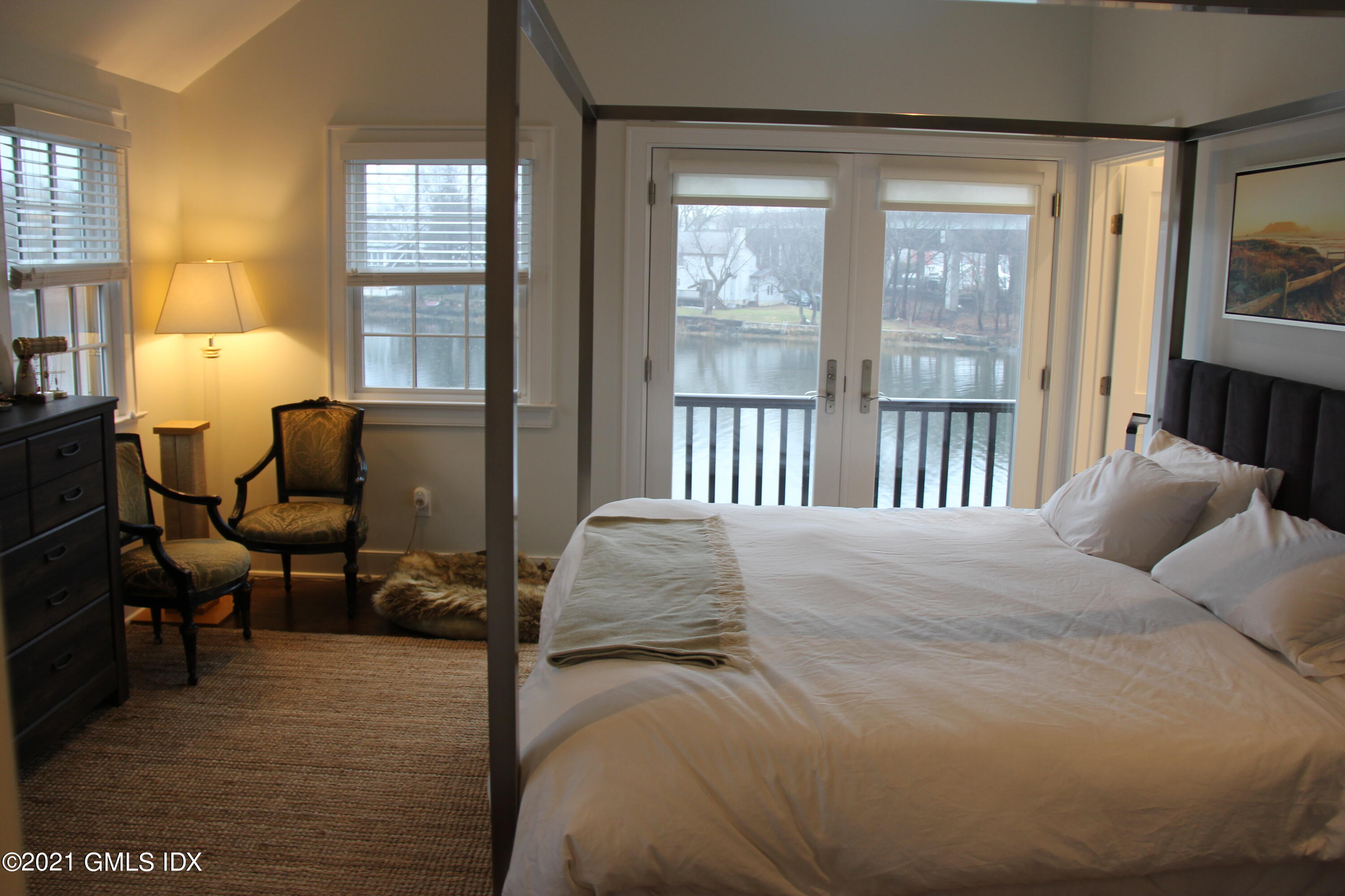 40 Strickland Road Cos Cob, CT 06807 - Photo 13 of 22 a bedroom with a bed and wooden floor