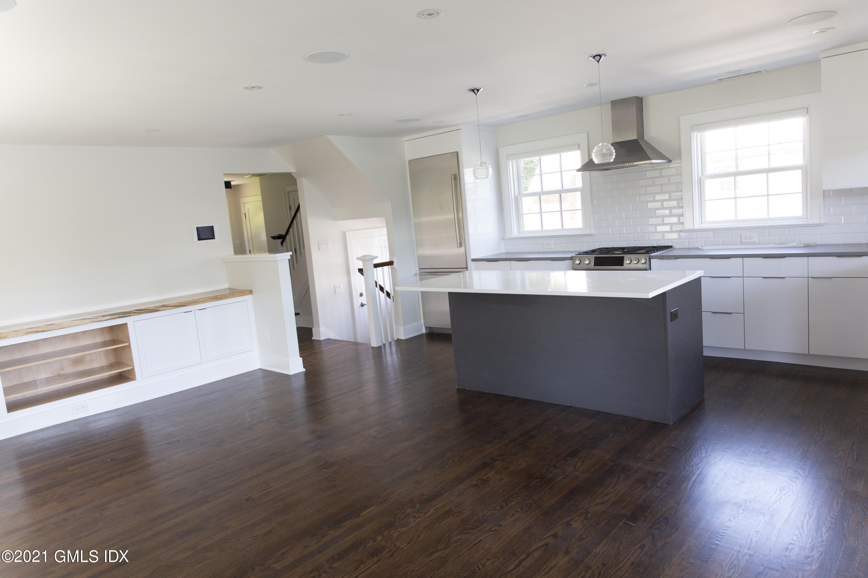 40 Strickland Road Cos Cob, CT 06807 - Photo 19 of 22 a large kitchen with stainless steel appliances a large counter top and a wooden floor