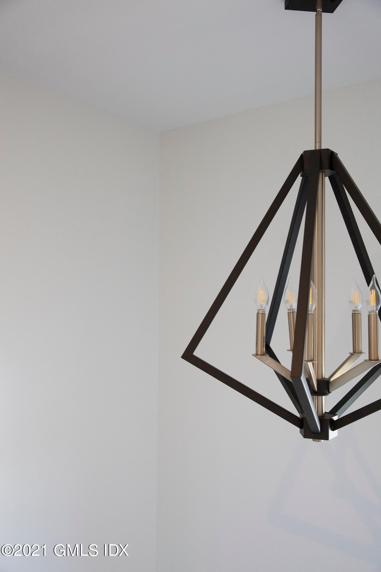 40 Strickland Road Cos Cob, CT 06807 - Photo 21 of 22 a view of staircase with a metal railing and a chandelier