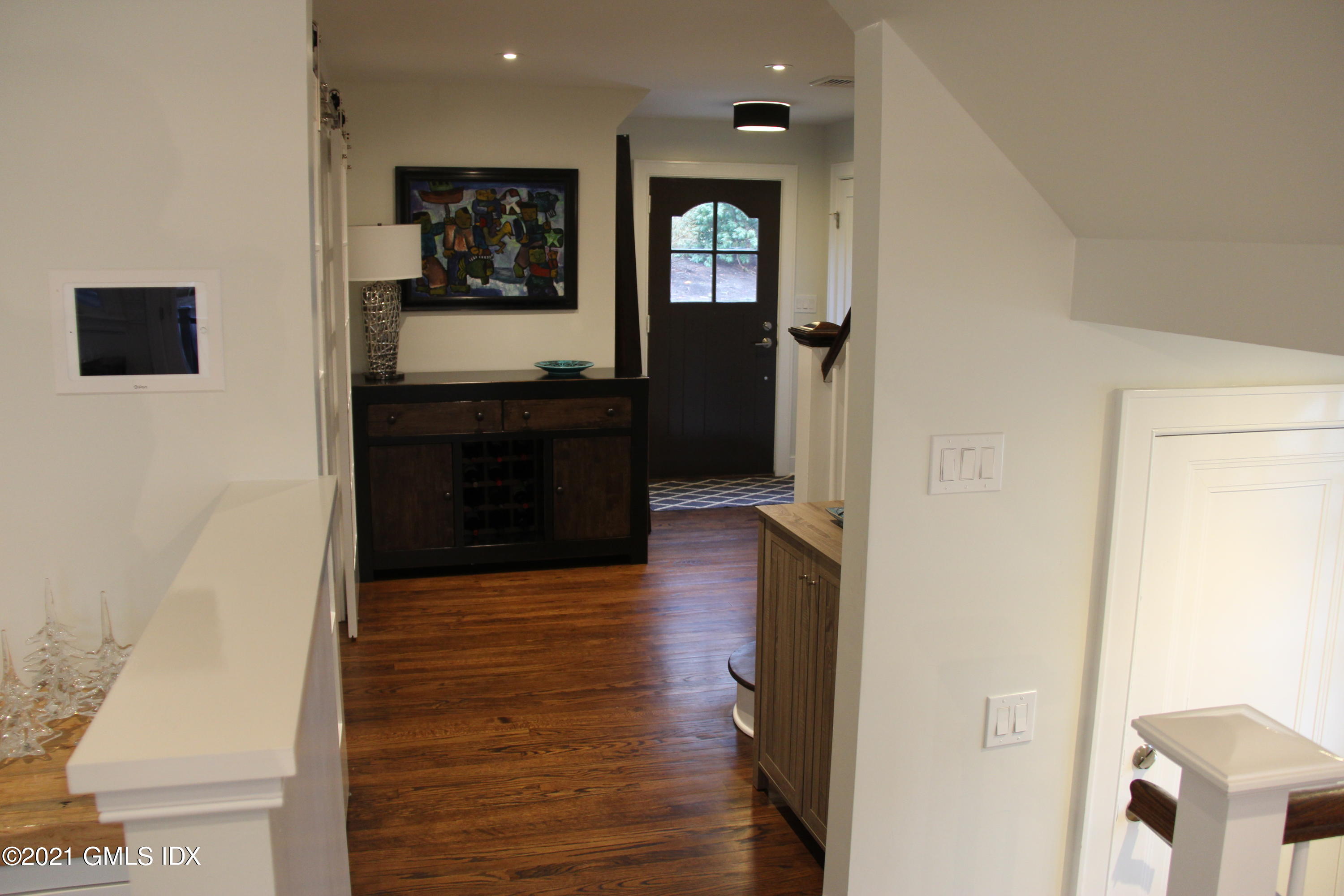 40 Strickland Road Cos Cob, CT 06807 - Photo 7 of 22 a view of a hallway view with wooden floor and living room with a wooden floor