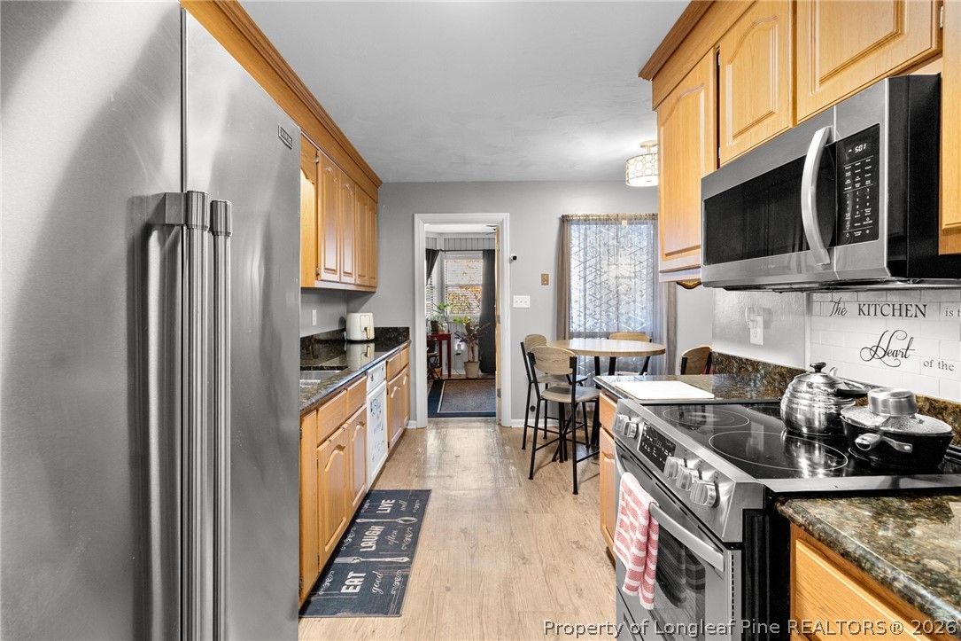 1912 Havilah Road Fayetteville, NC 28303 - Photo 4 of 14 a kitchen with stainless steel appliances granite countertop a stove a sink and a microwave