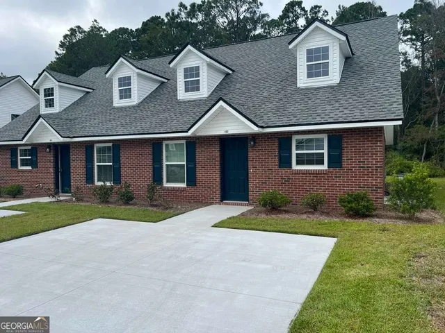 a front view of a house with a yard