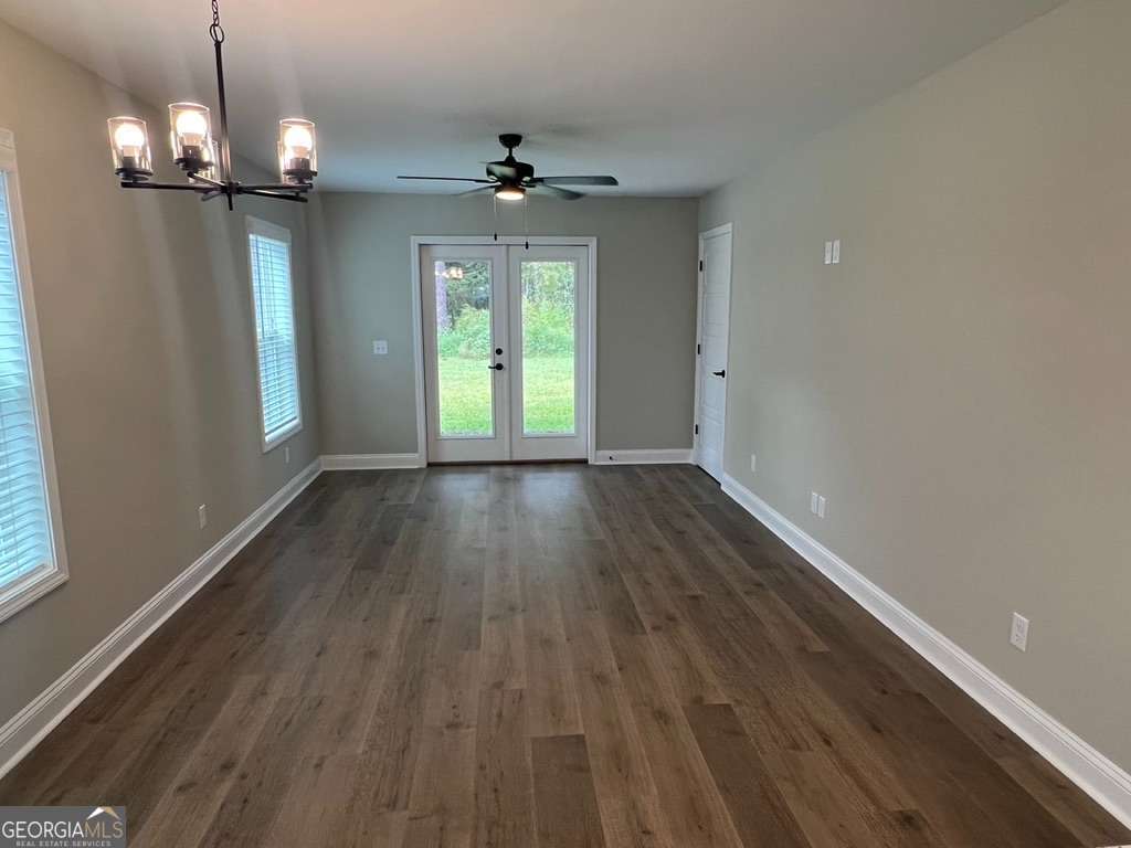 403 Madison Avenue St. Marys, GA 31558 - Photo 3 of 21 a view of an empty room with wooden floor and a window