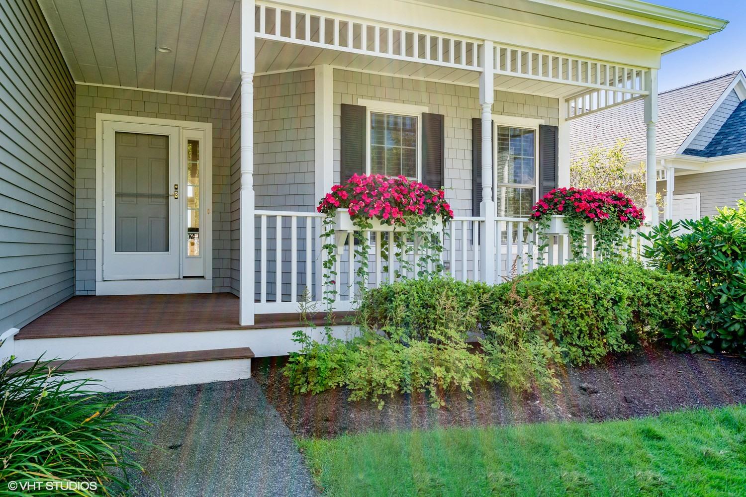 a front view of a house with plants