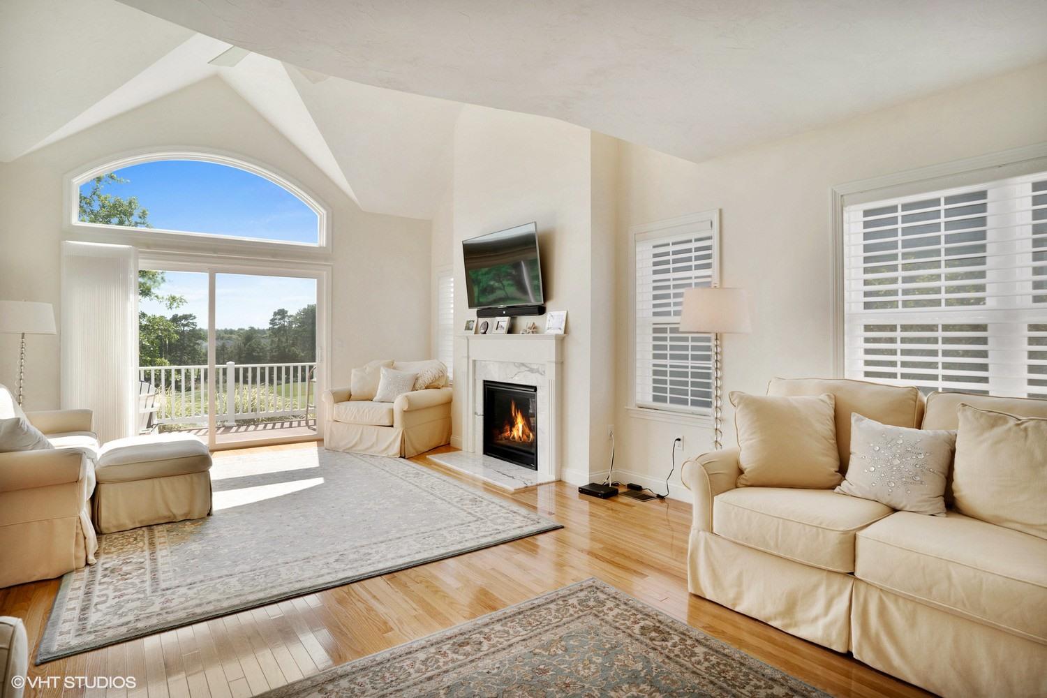 68 Brookside Road Bourne, MA 02532 - Photo 2 of 15 a living room with furniture a flat screen tv and a fireplace