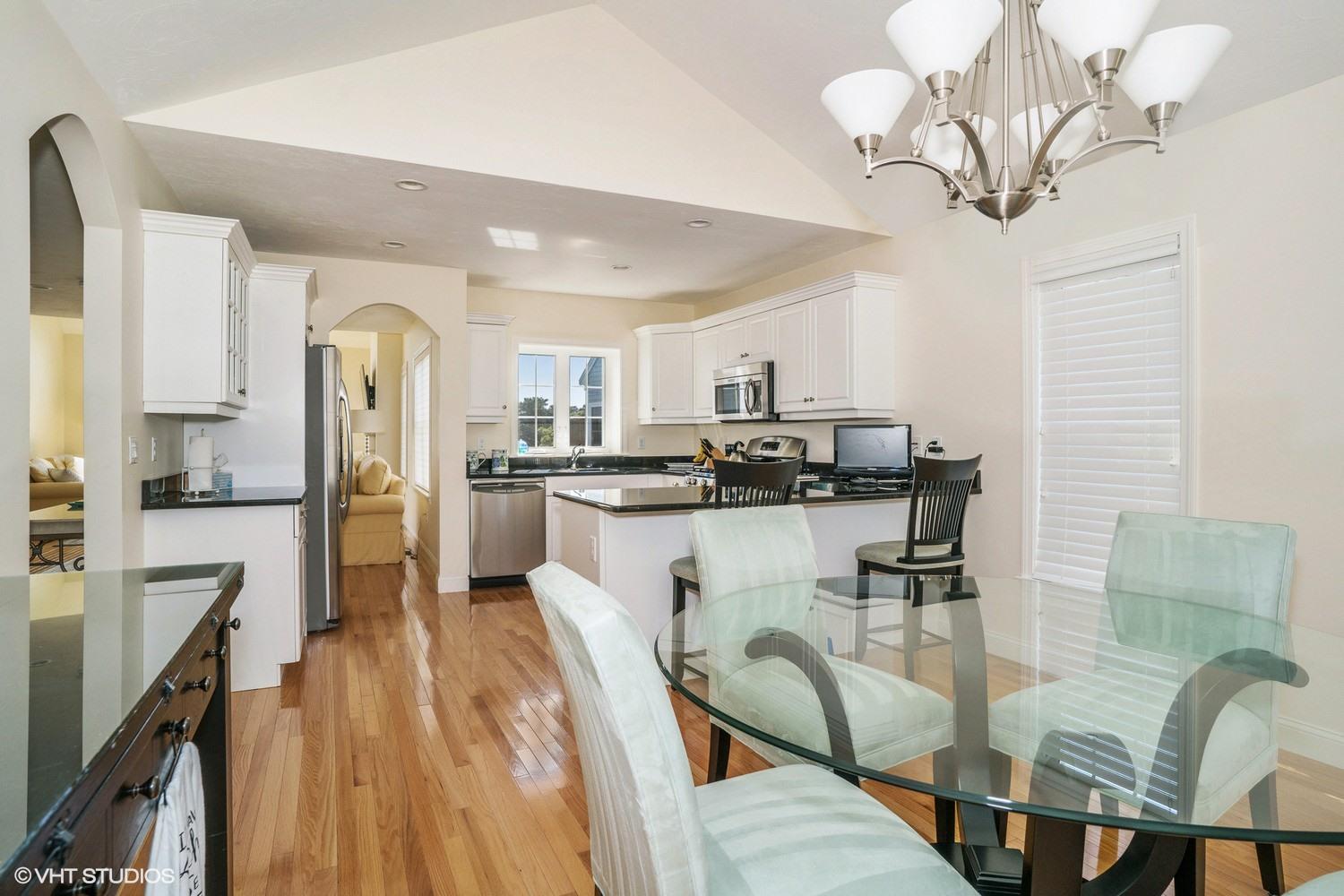 68 Brookside Road Bourne, MA 02532 - Photo 6 of 15 a kitchen with stainless steel appliances granite countertop a refrigerator a stove top oven a sink dishwasher and white cabinets with wooden floor
