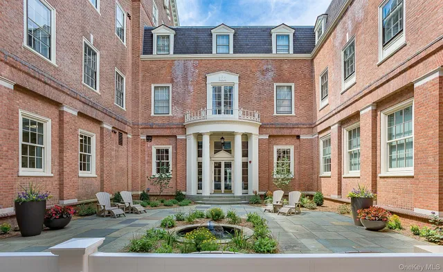 a front view of a brick building with many windows