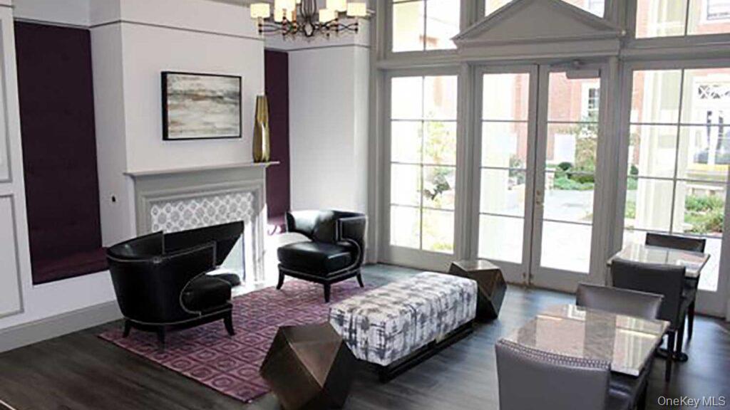 480 Bedford Road, Unit 210 Chappaqua, NY 10514 - Photo 10 of 11 a living room with furniture a fireplace and a floor to ceiling window