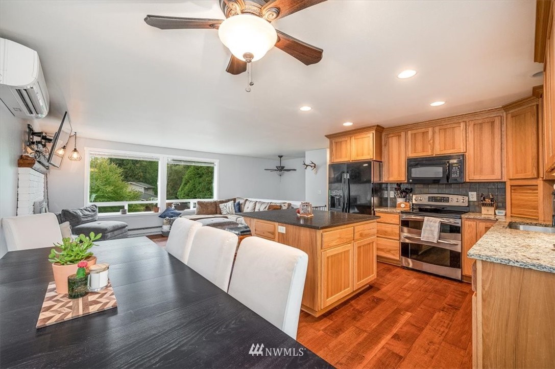 5942 Longdin Road Ferndale, WA 98248 - Photo 11 of 30 a large kitchen with lot of cabinets a sink a window and appliances