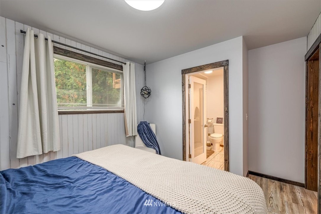 5942 Longdin Road Ferndale, WA 98248 - Photo 17 of 30 a bedroom with a bed wooden floor and a window