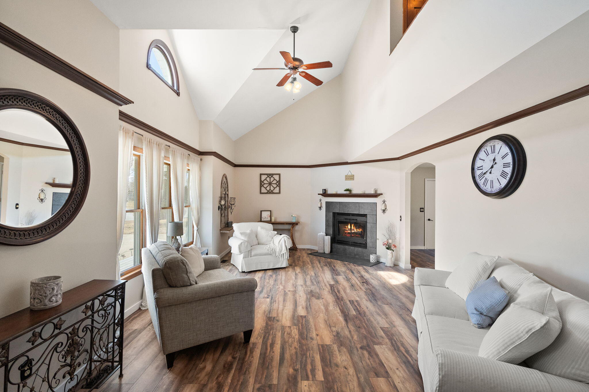 1790 West 134th Court Crown Point, IN 46307 - Photo 7 of 53 a living room with furniture a fireplace and a clock