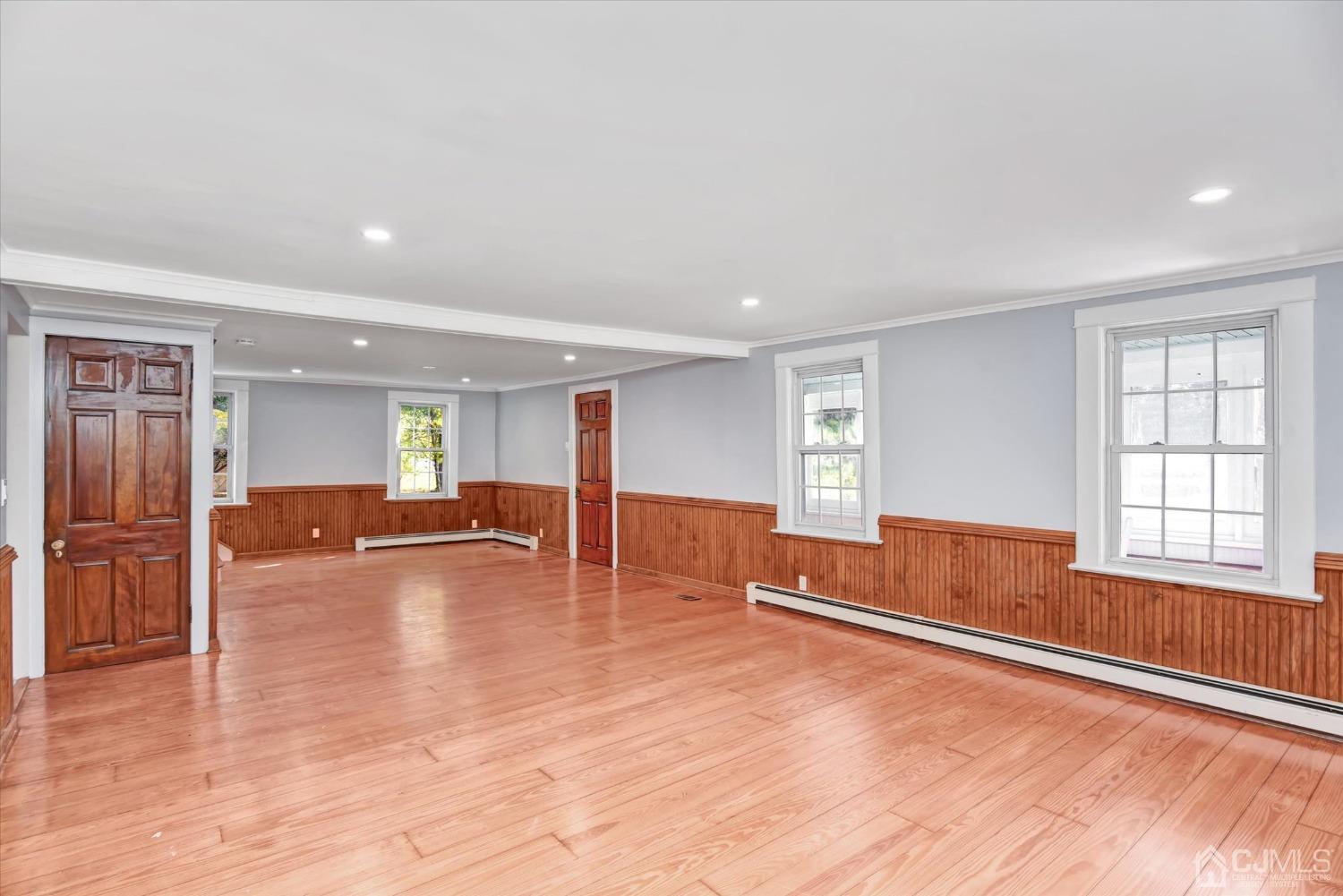 588 Adelphia Road Freehold, NJ 07728 - Photo 7 of 67 a view of empty room with wooden floor and fireplace